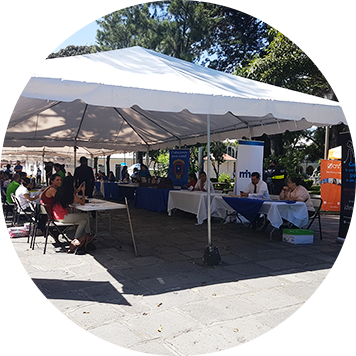 es una actividad con varios stands, en cada uno hay personas atendiendo a los visitantes.